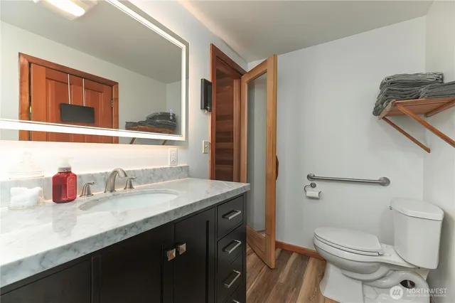 a bathroom with a granite countertop sink and a mirror