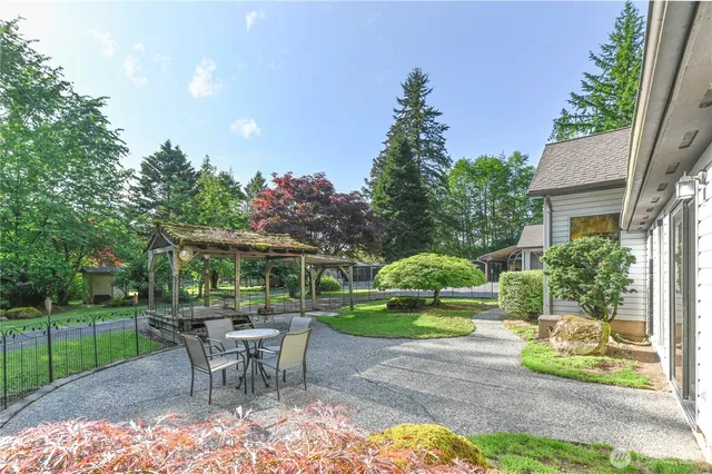 a view of a house with backyard sitting area and garden