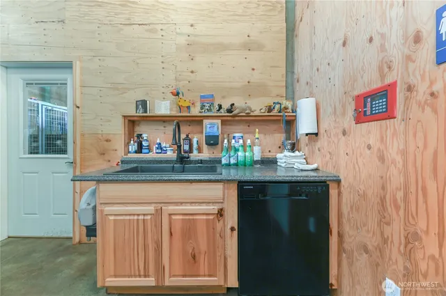an aerial view of a house with a yard and trees all around