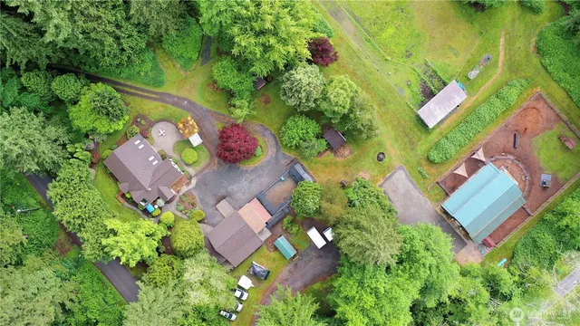 an aerial view of a house with a yard