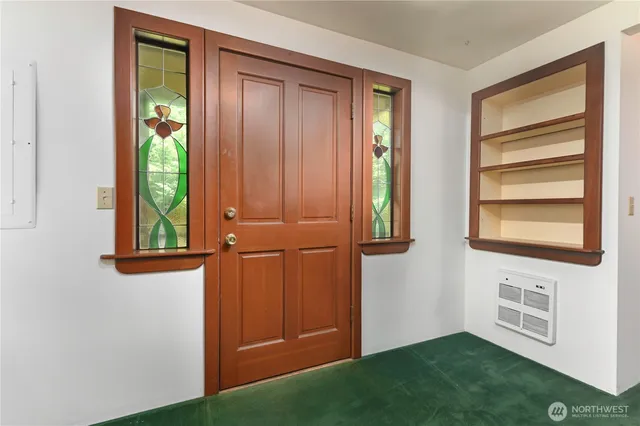 view of room with window and hallway