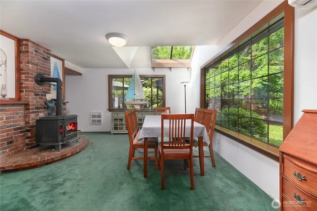 a dining room with furniture and a floor to ceiling window