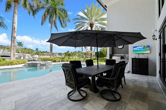 a view of a house with backyard and sitting area