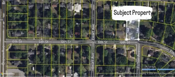 a view of a brick building with a tree in it