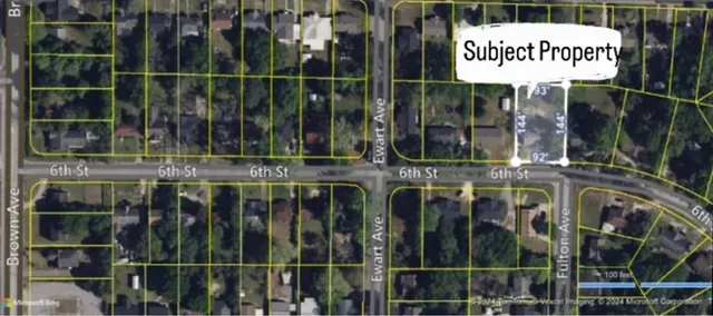 a view of a brick building with a tree in it