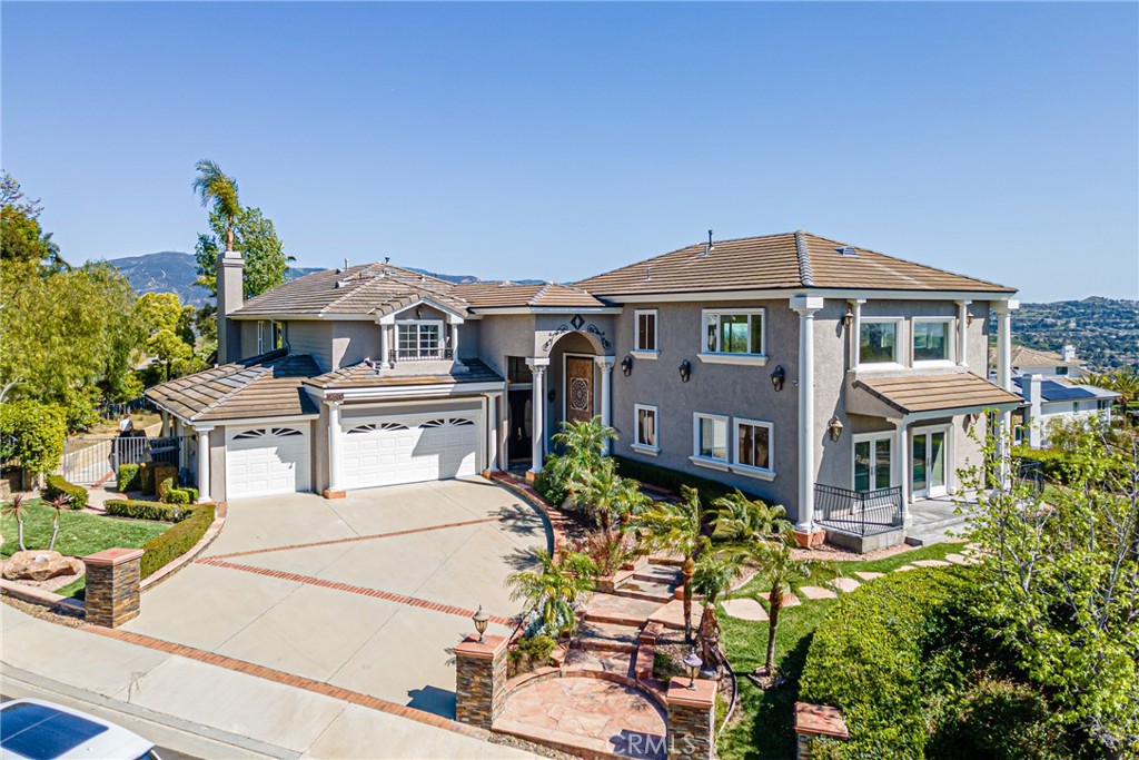 22600 Hidden Hills Road Yorba Linda, CA 92887 - Photo 1 of 1 a front view of a residential houses with yard