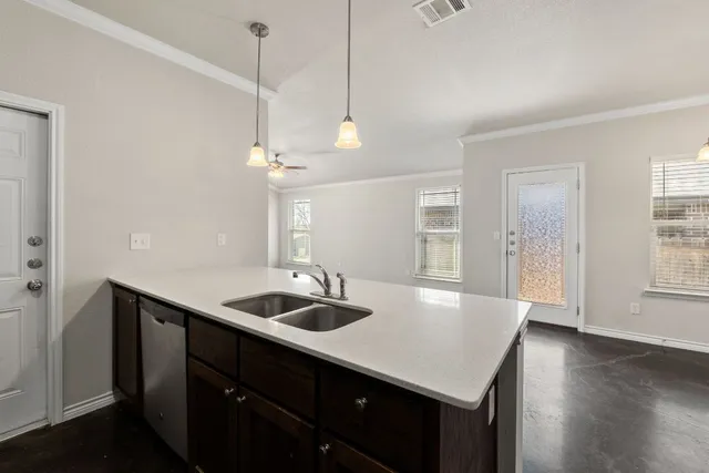 a kitchen with a sink stove and microwave