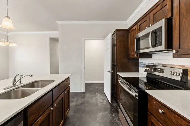 a kitchen with sink cabinets and wooden floor