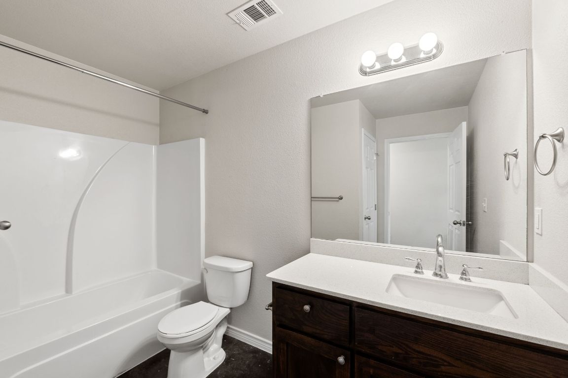 917 Ramblewood Street, Unit B Harker Heights, TX 76548 - Photo 15 of 39 a bathroom with a granite countertop sink toilet a large mirror and shower