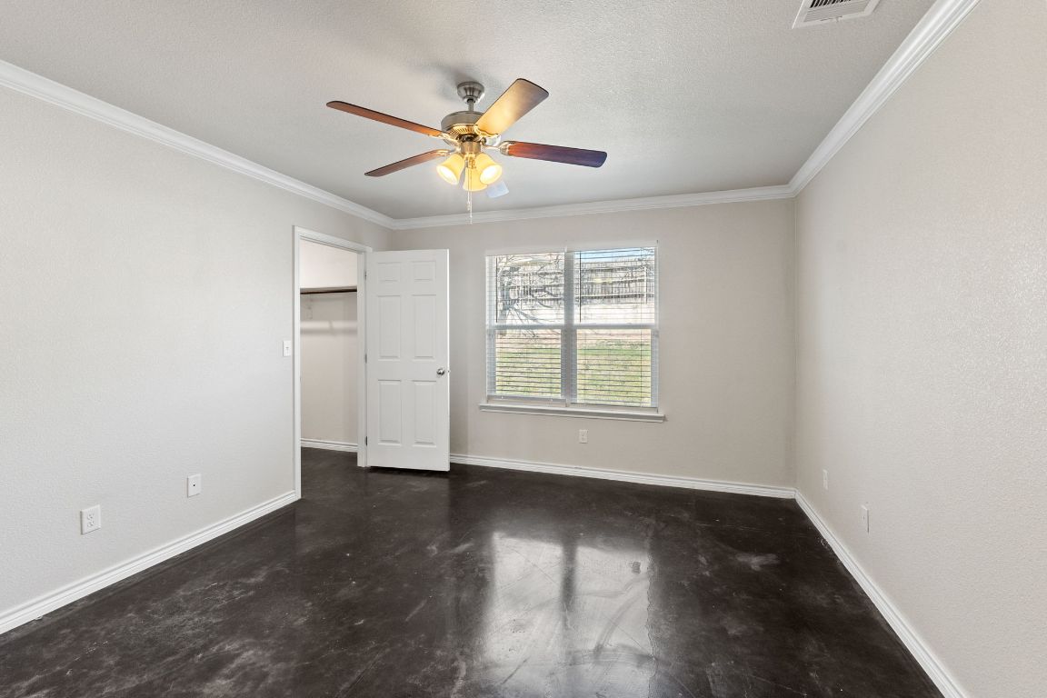 917 Ramblewood Street, Unit B Harker Heights, TX 76548 - Photo 23 of 39 an empty room with wooden floor fan and windows