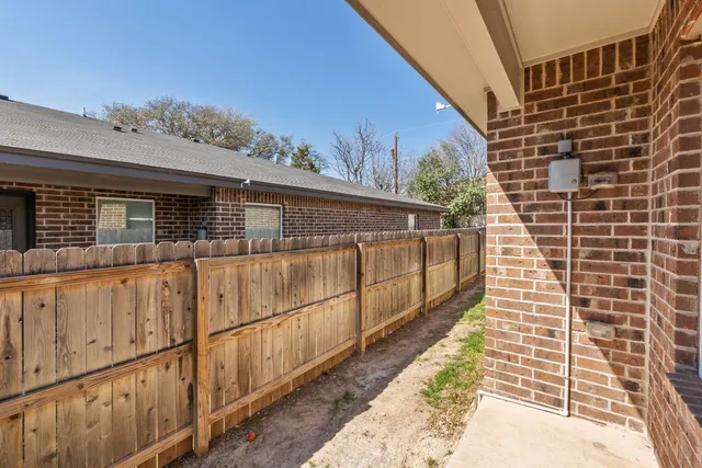 a view of a house with wooden fence