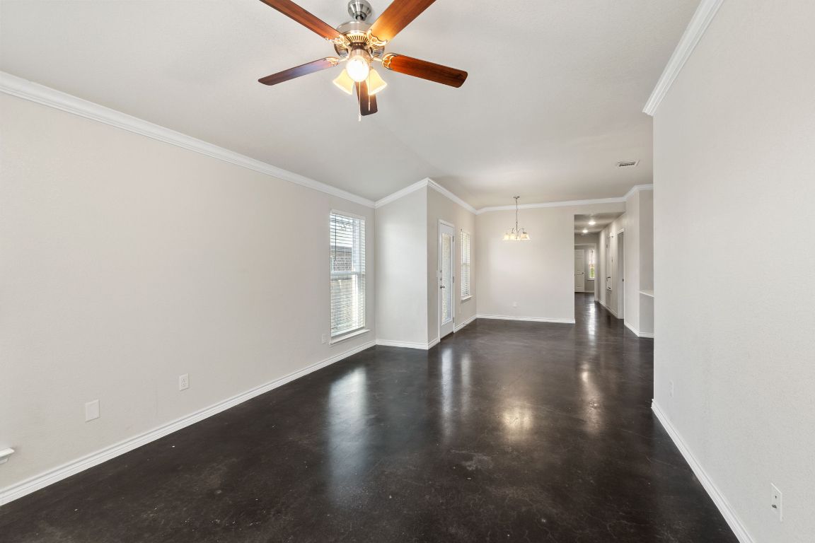 917 Ramblewood Street, Unit B Harker Heights, TX 76548 - Photo 4 of 39 an empty room with wooden floor fan and windows