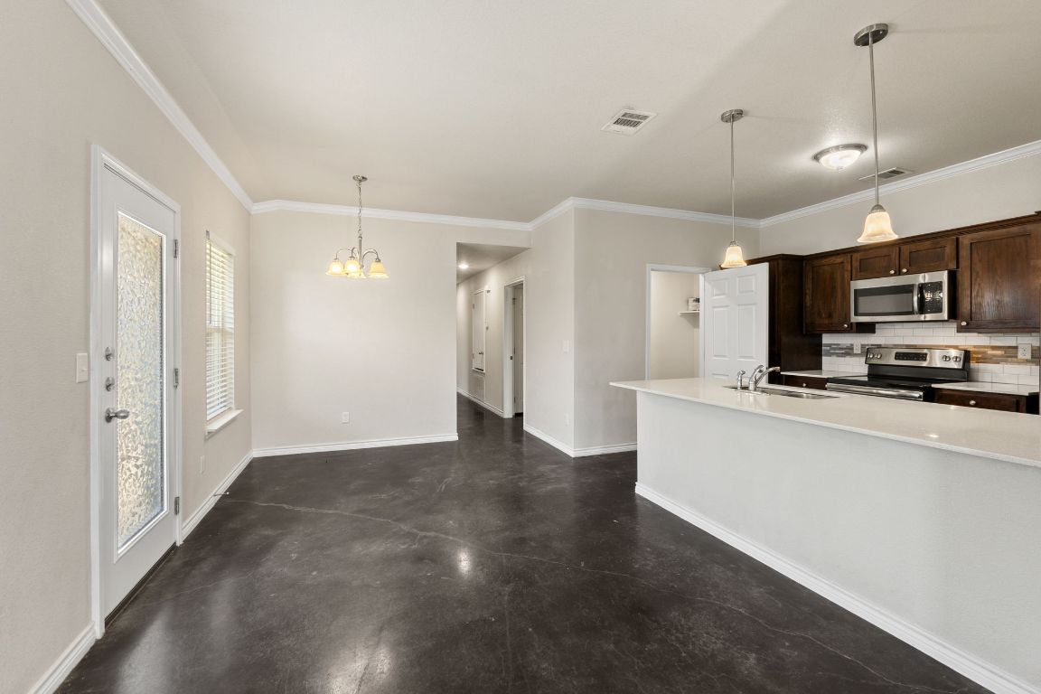 917 Ramblewood Street, Unit B Harker Heights, TX 76548 - Photo 8 of 39 a view of a kitchen with a sink and a refrigerator