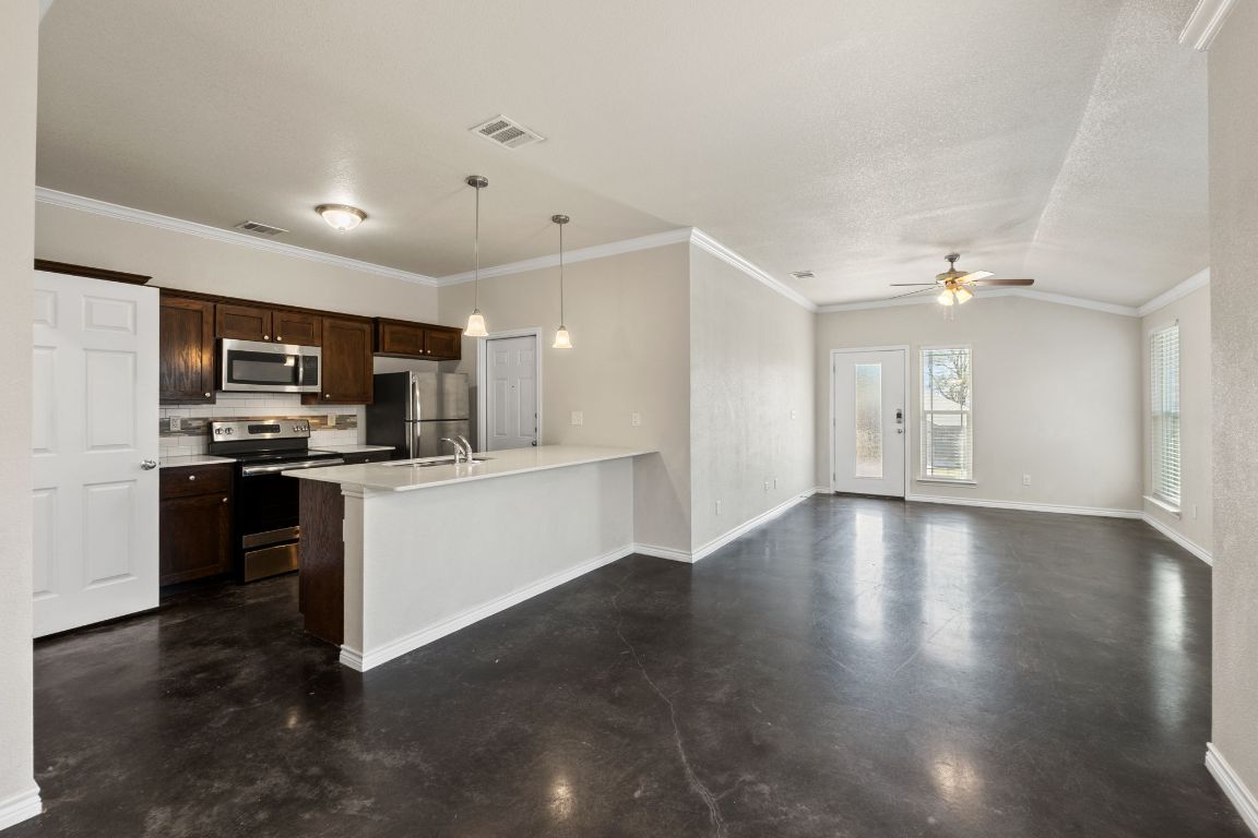 917 Ramblewood Street, Unit B Harker Heights, TX 76548 - Photo 39 of 39 a view of a kitchen with a sink and dishwasher a stove top oven with wooden floor