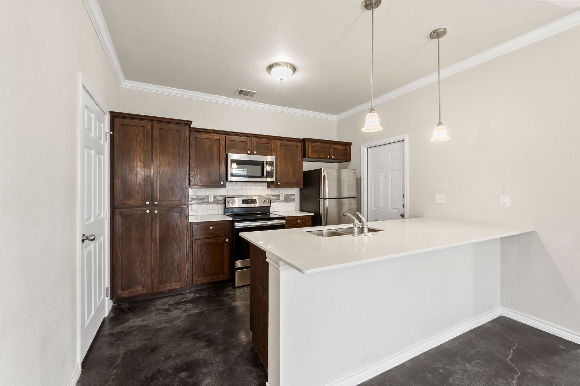 917 Ramblewood Street, Unit B Harker Heights, TX 76548 - Photo 9 of 39 a kitchen with stainless steel appliances a refrigerator sink and microwave