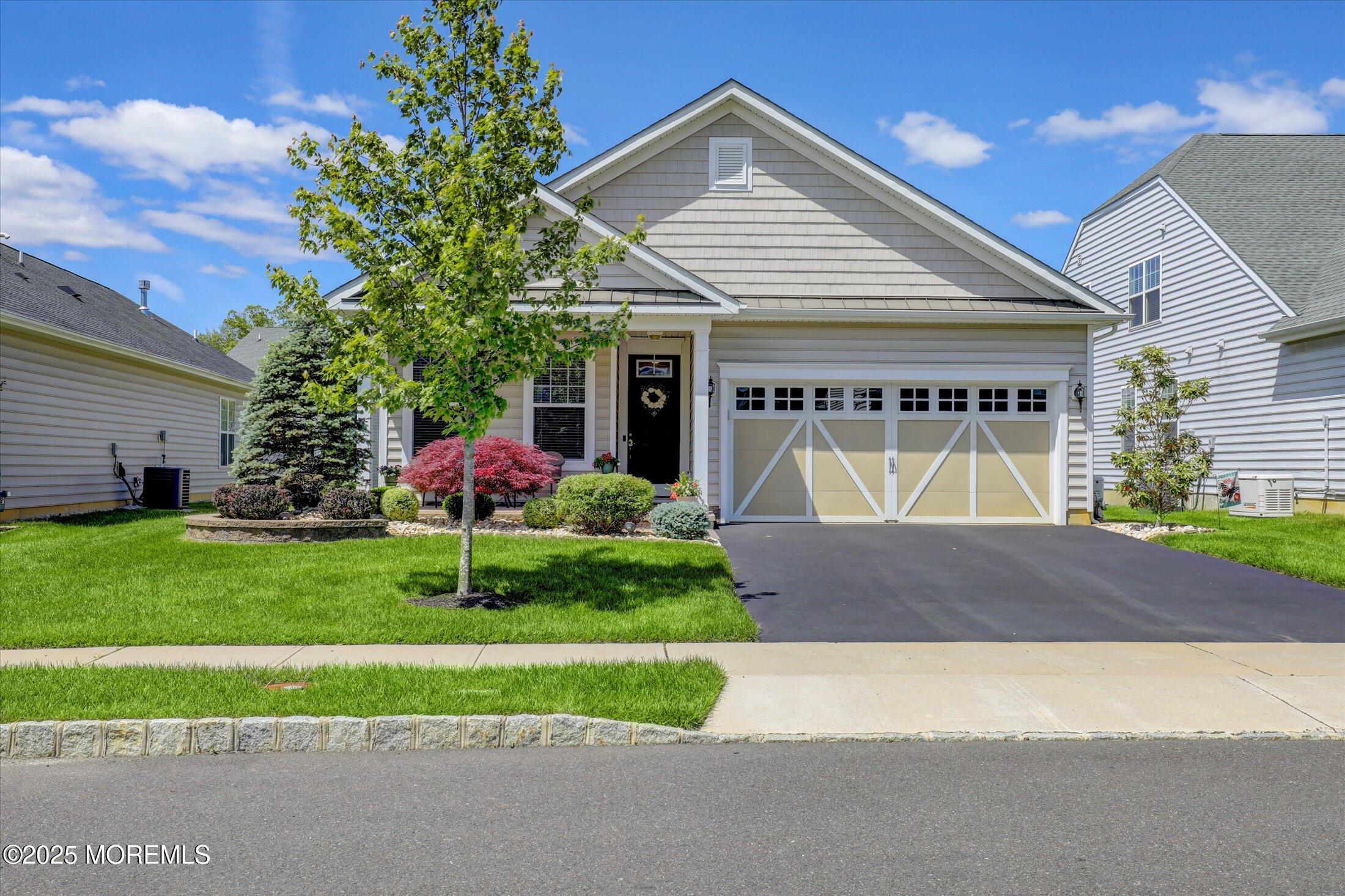 24 Moonlight Way Howell, NJ 07731 - Photo 1 of 34 a front view of a house with a yard and garage