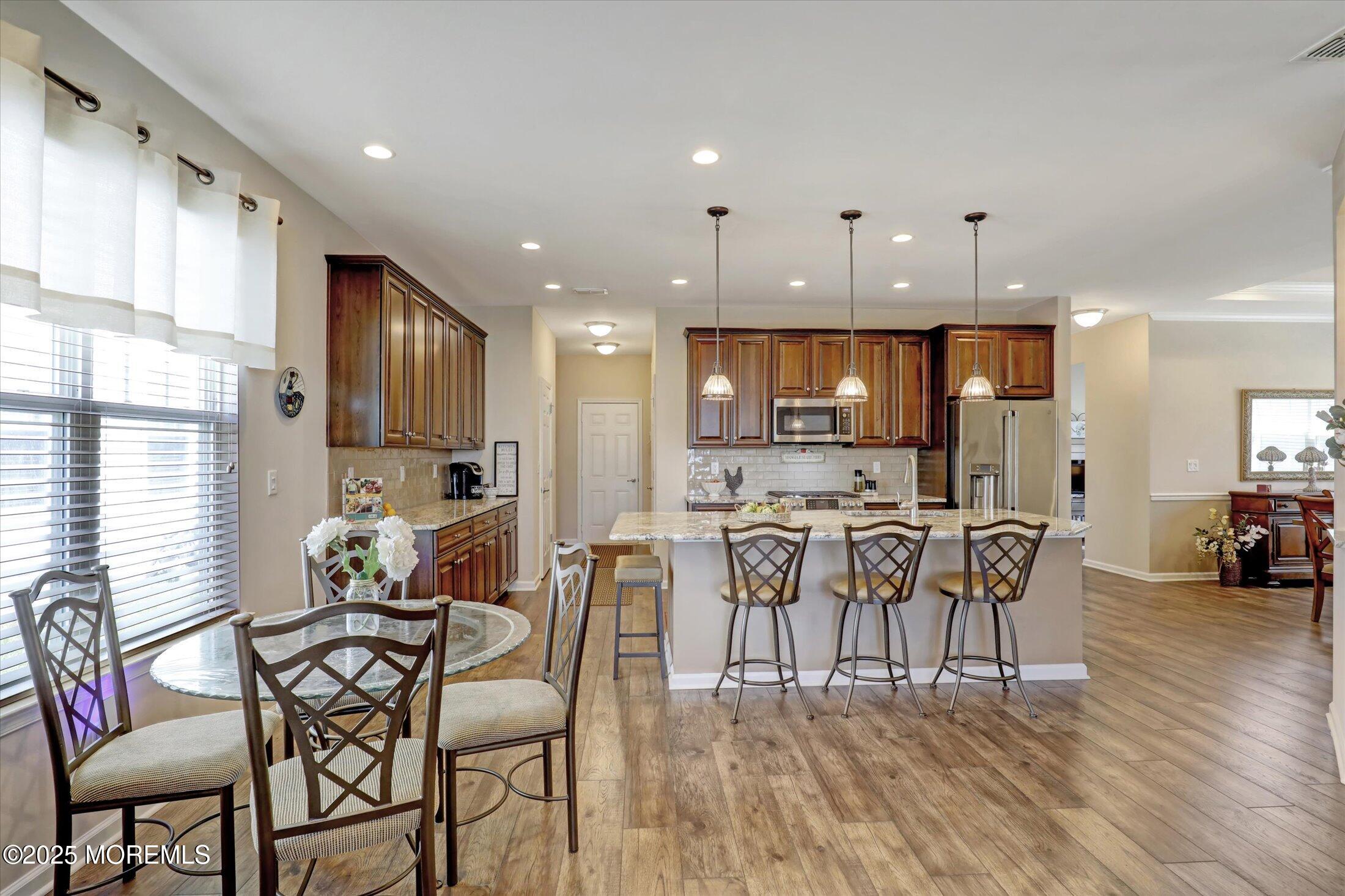 24 Moonlight Way Howell, NJ 07731 - Photo 12 of 34 a view of a dining room with furniture and wooden floor