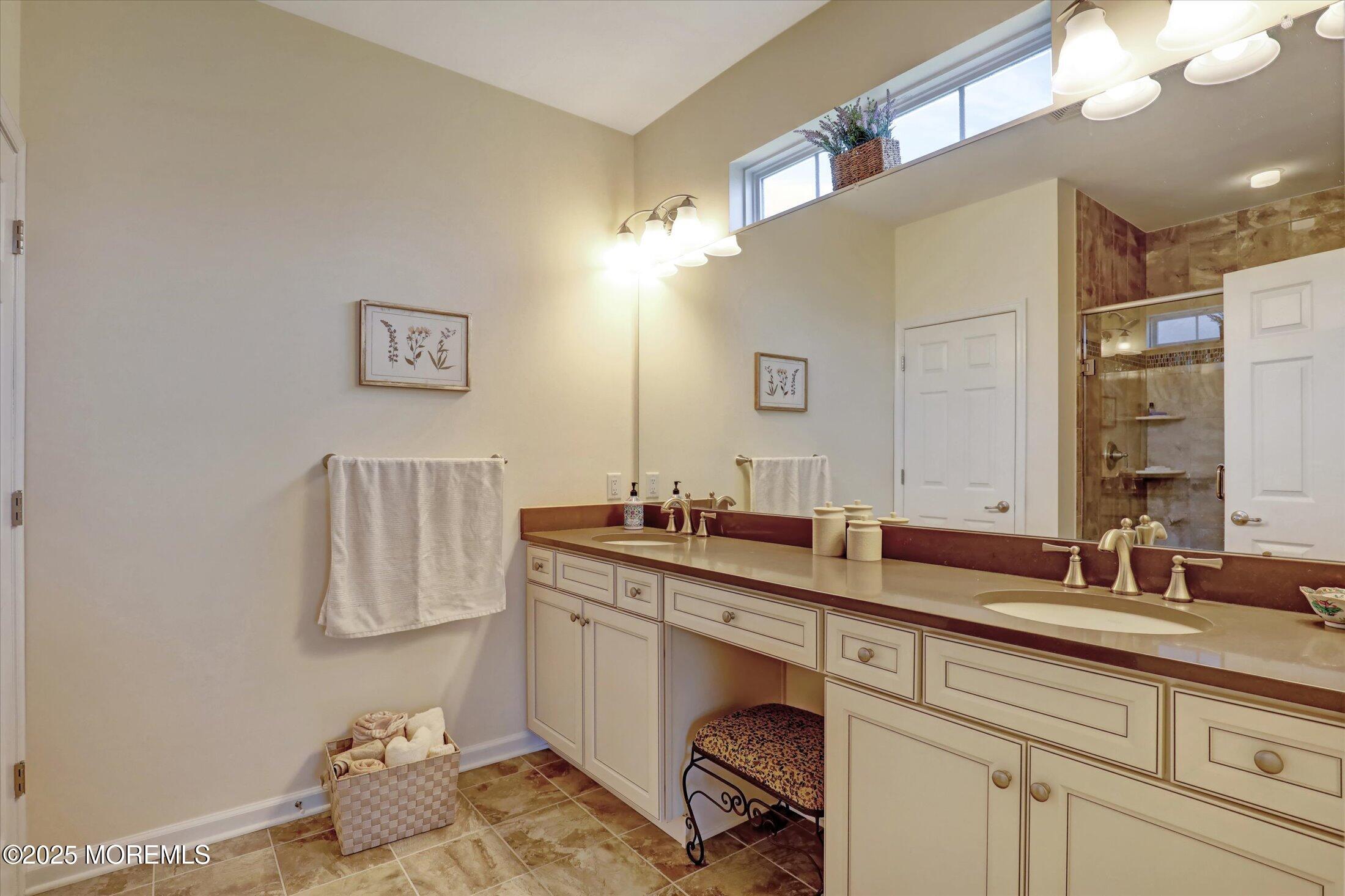 24 Moonlight Way Howell, NJ 07731 - Photo 23 of 34 a bathroom with a sink mirror and vanity