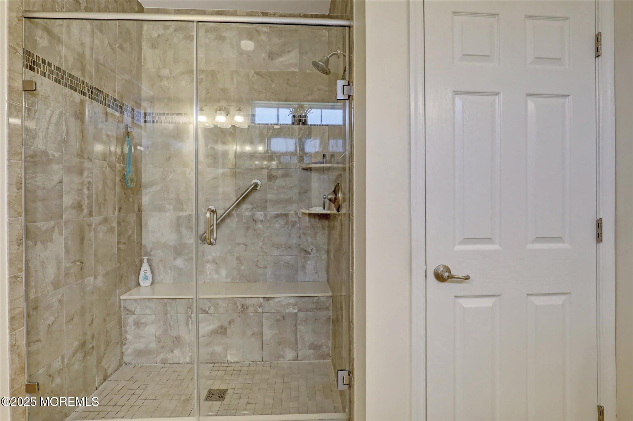 24 Moonlight Way Howell, NJ 07731 - Photo 24 of 34 a bathroom with a glass shower door