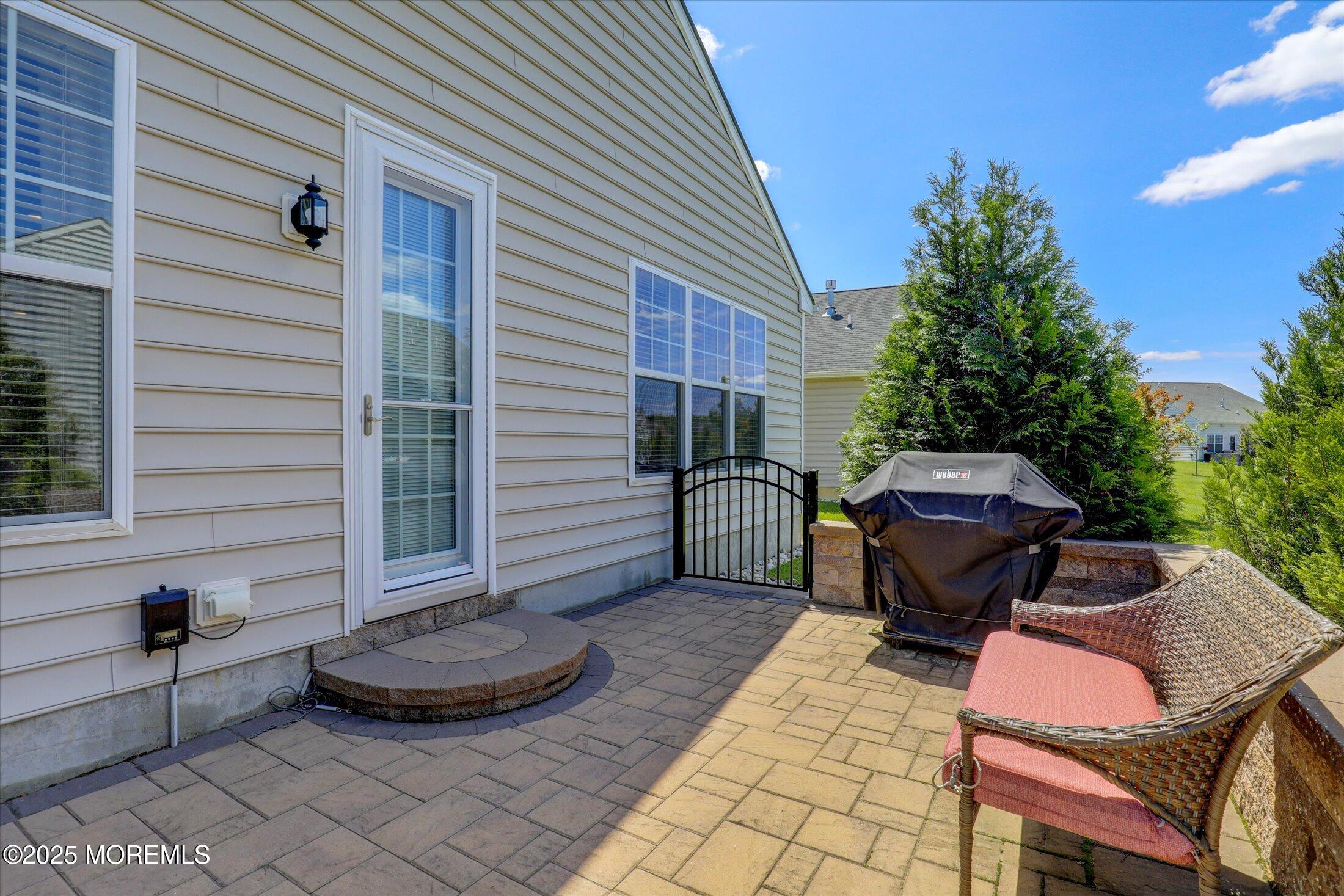 24 Moonlight Way Howell, NJ 07731 - Photo 29 of 34 a view of a patio with chair and tables back yard of the house