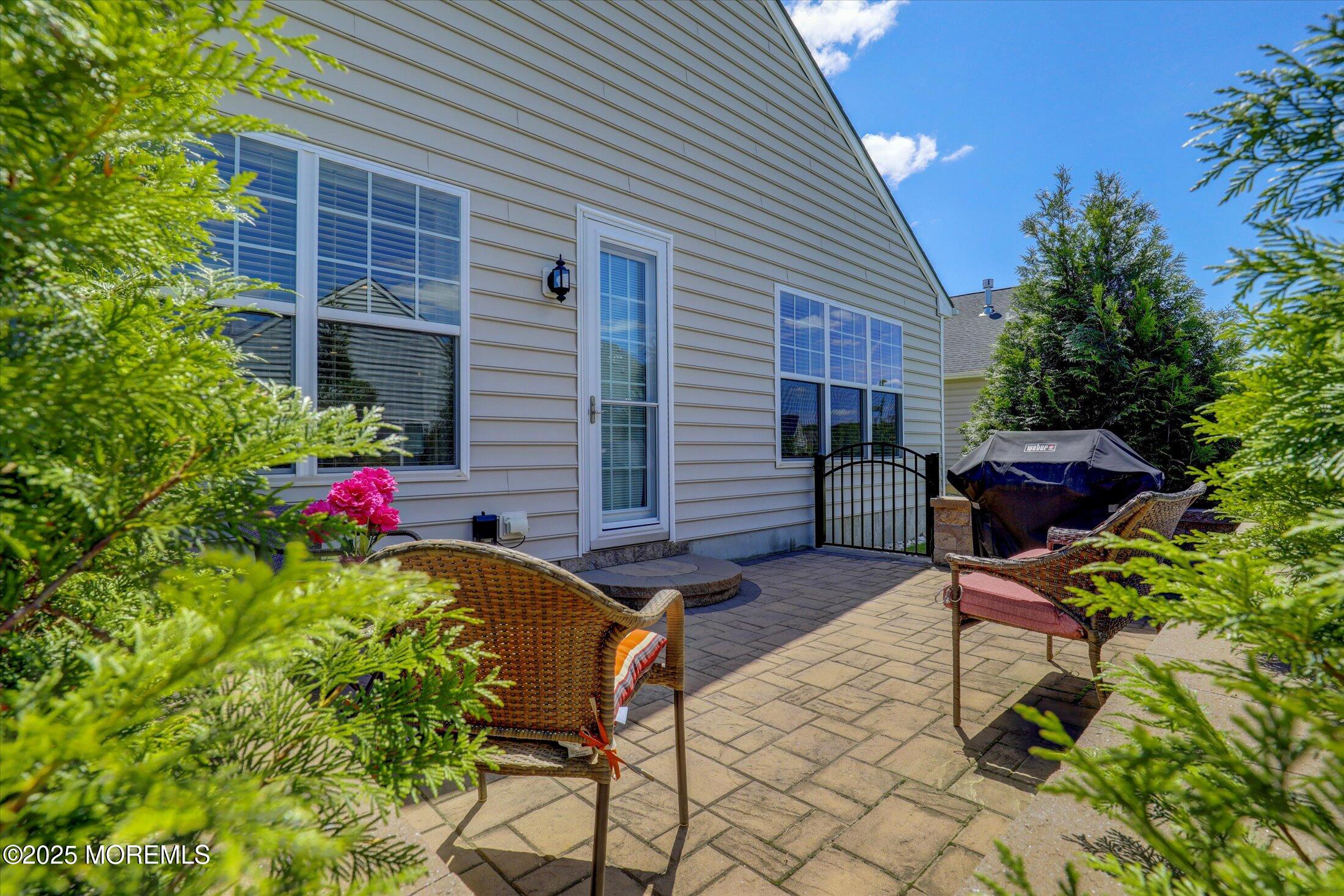 24 Moonlight Way Howell, NJ 07731 - Photo 31 of 34 a view of a patio with table and chairs and potted plants