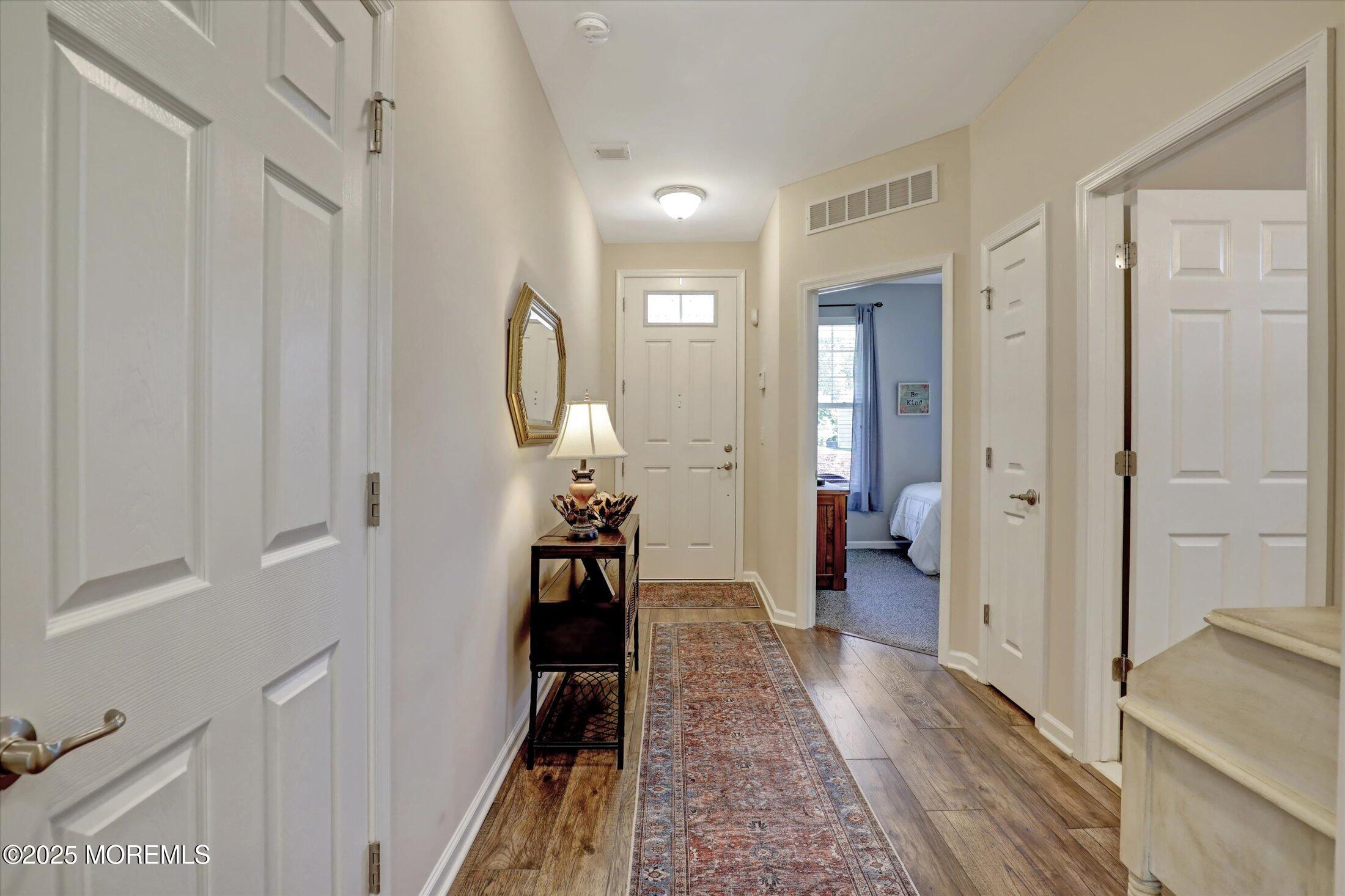 24 Moonlight Way Howell, NJ 07731 - Photo 4 of 34 a view of a hallway with wooden floor windows and a livingroom