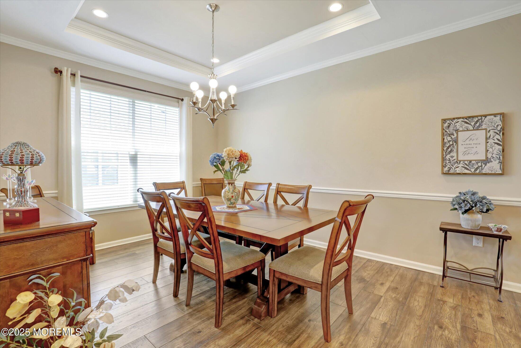 24 Moonlight Way Howell, NJ 07731 - Photo 7 of 34 a dining room with furniture a chandelier and wooden floor