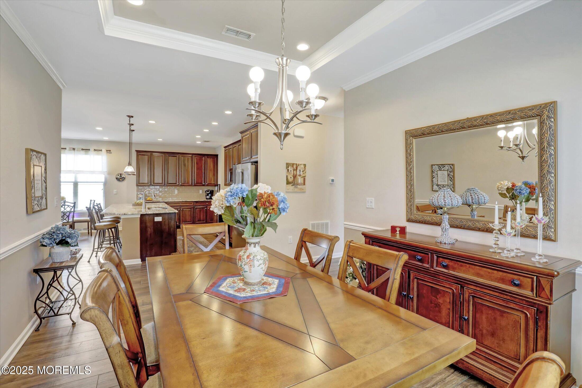 24 Moonlight Way Howell, NJ 07731 - Photo 8 of 34 a living room with furniture kitchen and a chandelier