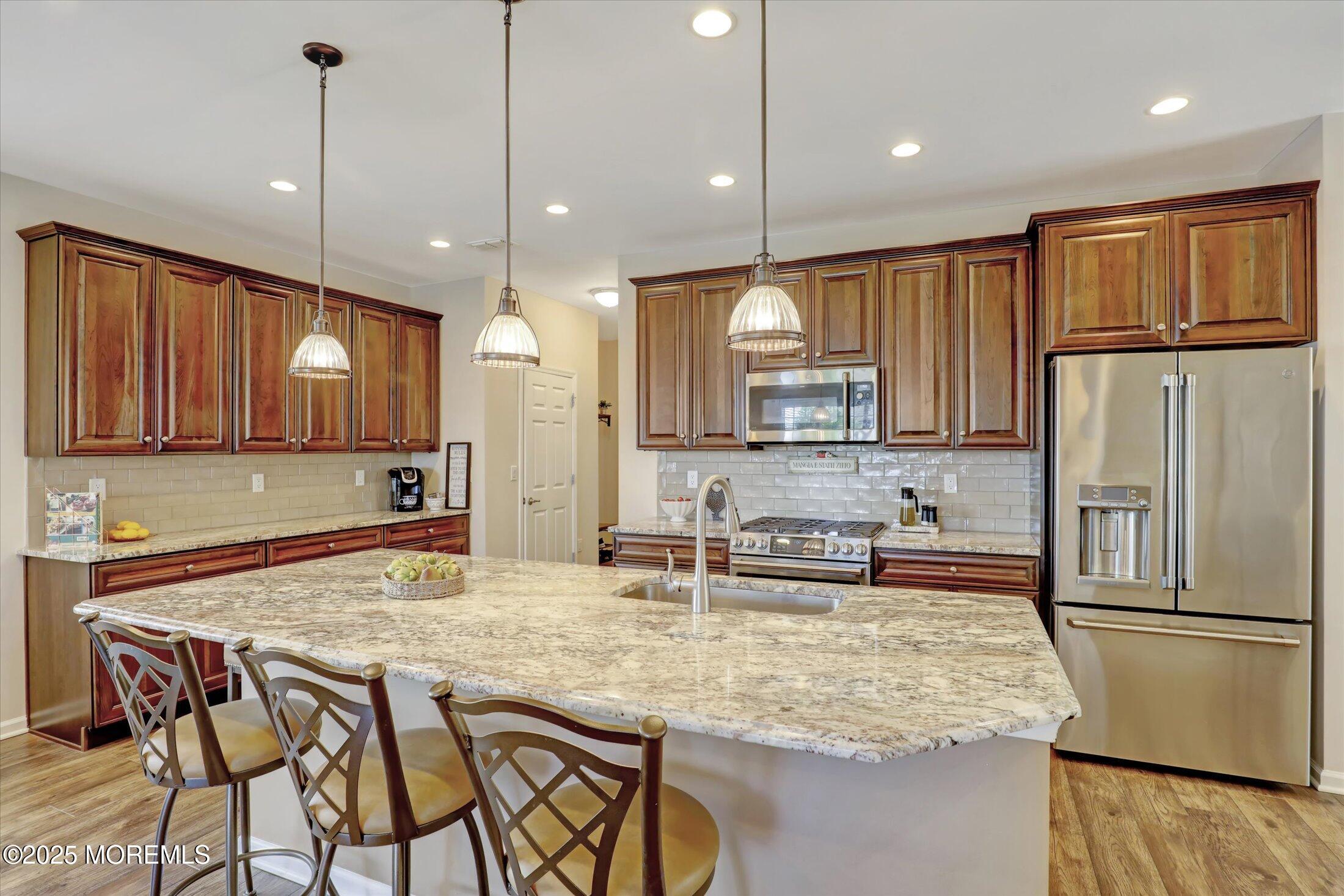 24 Moonlight Way Howell, NJ 07731 - Photo 9 of 34 a kitchen with stainless steel appliances granite countertop a sink refrigerator and cabinets