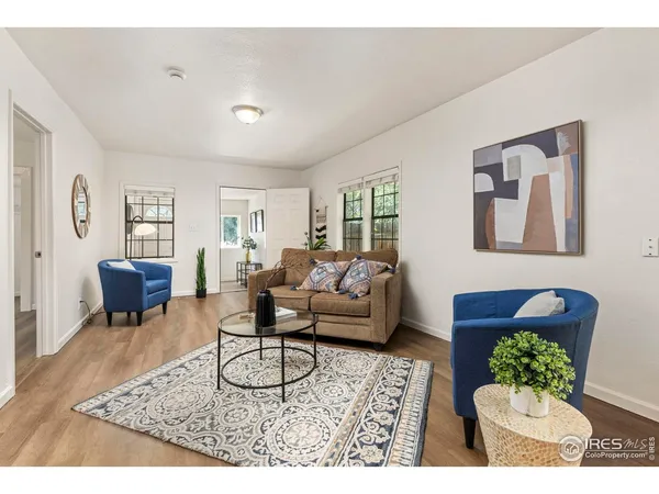 a living room with furniture potted plant and a window