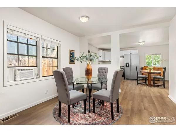a dining room with furniture and wooden floor