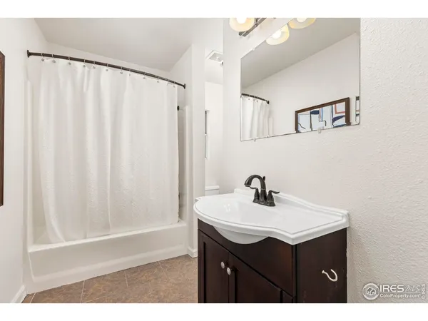 a bathroom with a sink vanity and a mirror