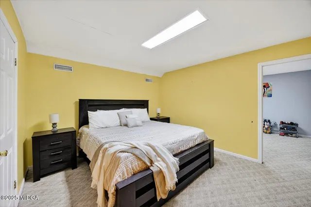 a bedroom with a bed and dresser