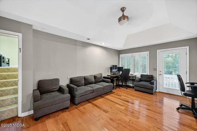 a living room with furniture and a large window