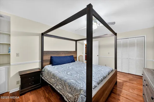 a bedroom with a bed and a dresser