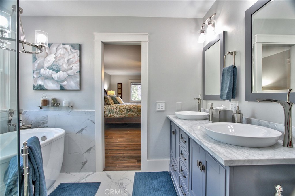 40791 Daily Road Fallbrook, CA 92028 - Photo 16 of 41 a en suite bathroom with a granite countertop sink and a mirror