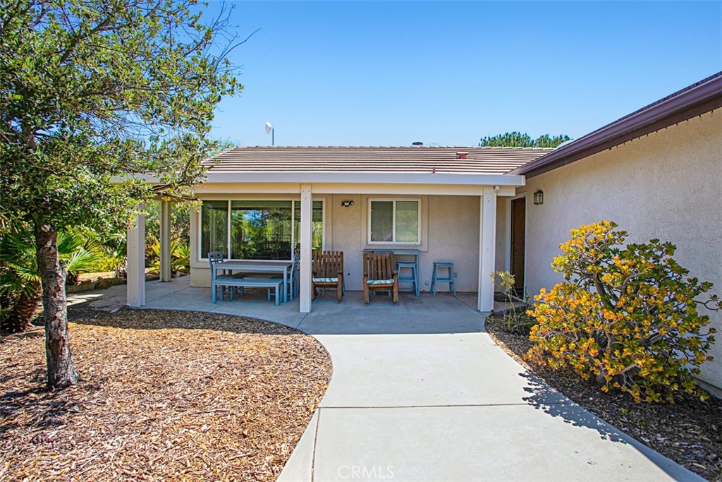 40791 Daily Road Fallbrook, CA 92028 - Photo 34 of 41 a view of a patio with table and chairs potted plants and large tree