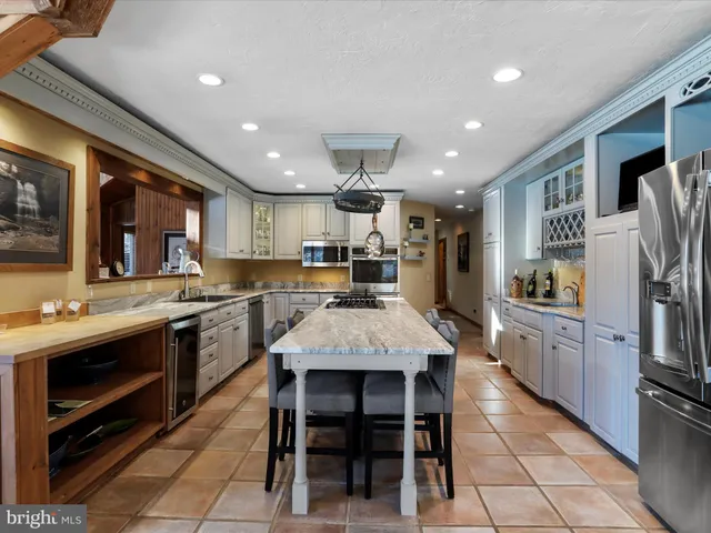 a kitchen with stainless steel appliances granite countertop a refrigerator and stove