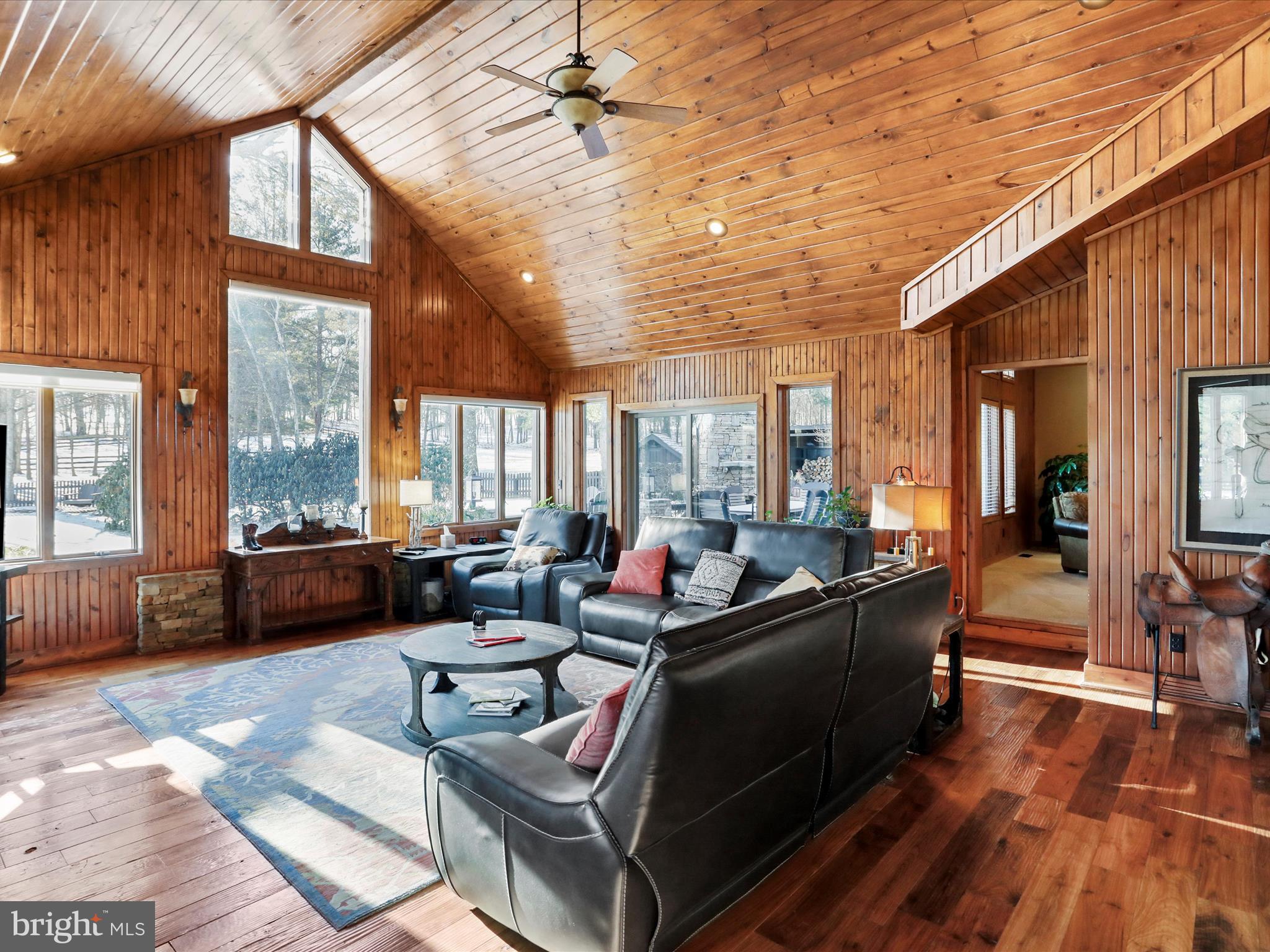 1240 Boy Scout Road Oakland, MD 21550 - Photo 31 of 148 a living room with furniture large windows and wooden floor