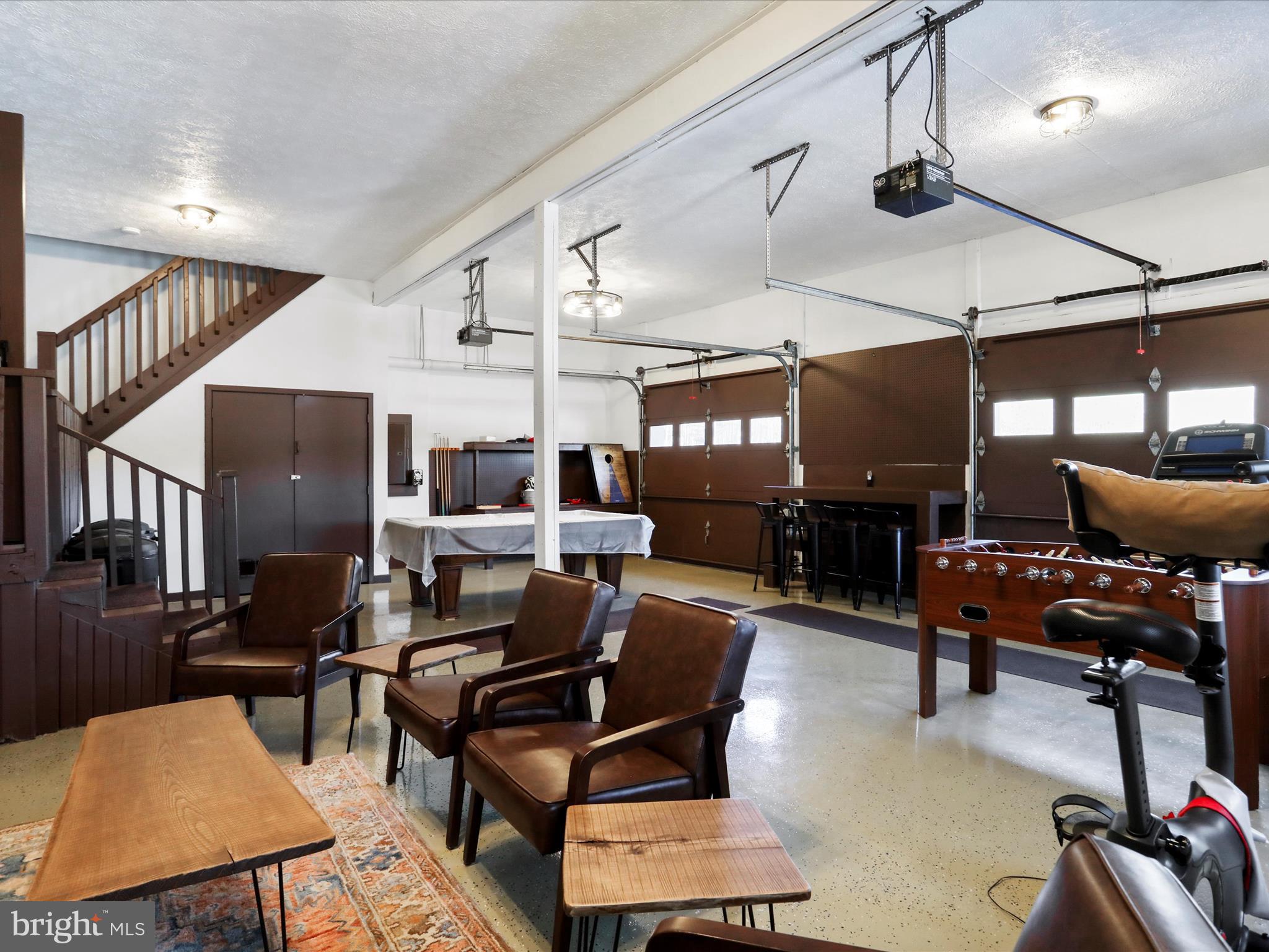 1240 Boy Scout Road Oakland, MD 21550 - Photo 52 of 148 a living room with furniture a flat screen tv and a table