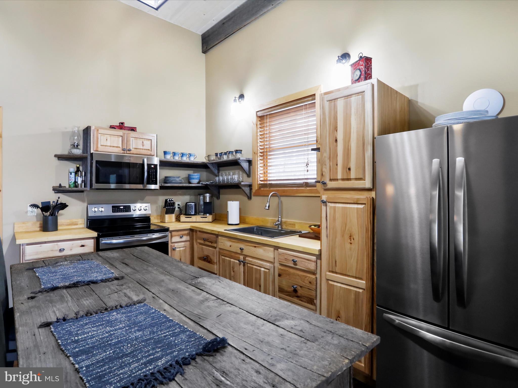 1240 Boy Scout Road Oakland, MD 21550 - Photo 87 of 148 a kitchen with stainless steel appliances granite countertop a refrigerator and stove