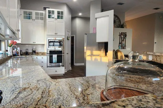 a kitchen with a sink cabinets and window