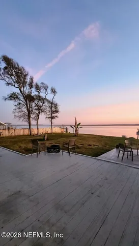 a front view of a house with wooden fence