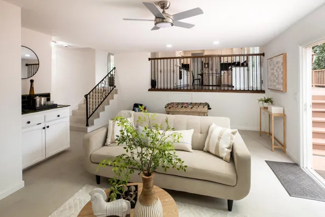 a living room with furniture and white walls