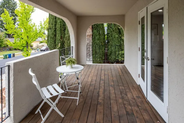a view of a balcony with table and chairs