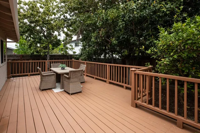 a view of balcony with wooden floor and seating space