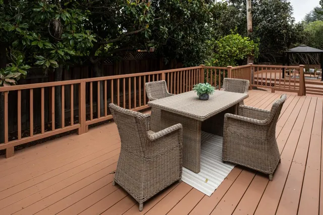 a view of balcony with furniture and trees