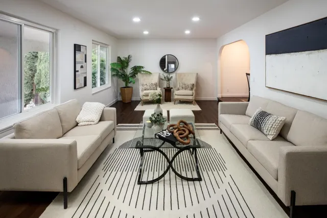 a living room with furniture and a wooden floor