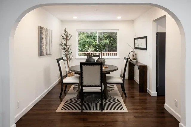 a dining room with furniture and wooden floor