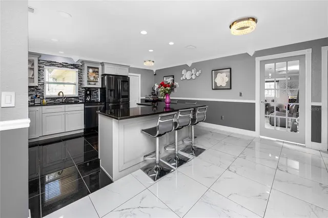 a kitchen with stainless steel appliances a stove a sink and a refrigerator